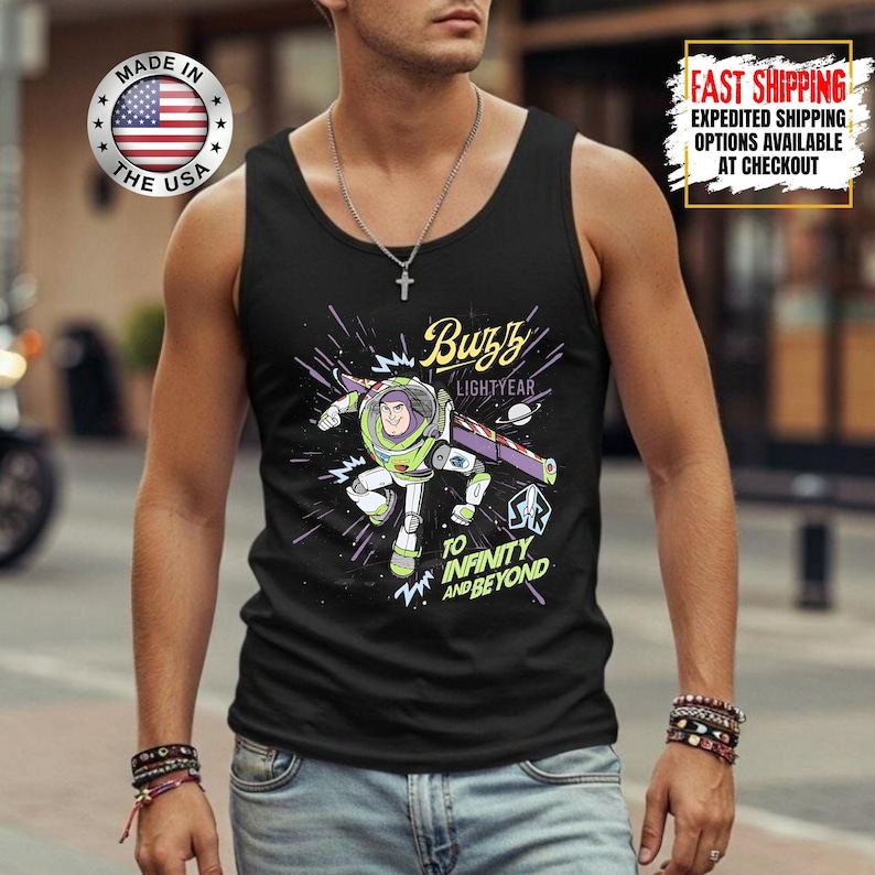 May include: Black vest top with a Buzz Lightyear graphic from Toy Story. The design includes the text "Buzz Lightyear" and "To Infinity and Beyond" with a space-themed background. The vest top also has a "Made in the USA" logo.