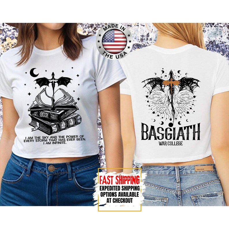 May include: White crop top with a black graphic design featuring a dragon, books, and the text "I AM THE SKY AND THE POWER OF EVERY STORM THAT HAS EVER BEEN. I AM INFINITE." The back of the shirt has the text "BASGIATH WAR COLLEGE."