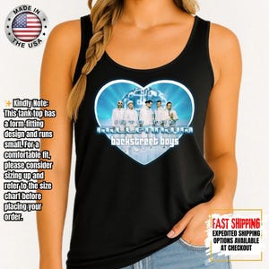 May include: Black tank top featuring a heart-shaped graphic with the text "Into the Millennium" and "Backstreet Boys." The graphic includes a photo of the band members. The tank top has a scoop neck and is made in the USA.