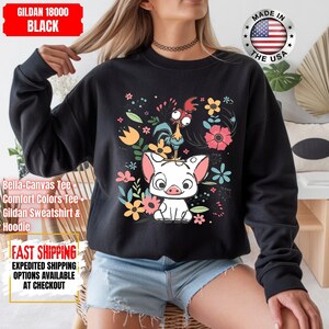 May include: Black sweatshirt with a colourful graphic of a pig, rooster, and flowers. The sweatshirt has the text "GILDAN 18000 BLACK" at the top. The words "MADE IN THE USA" are also visible.