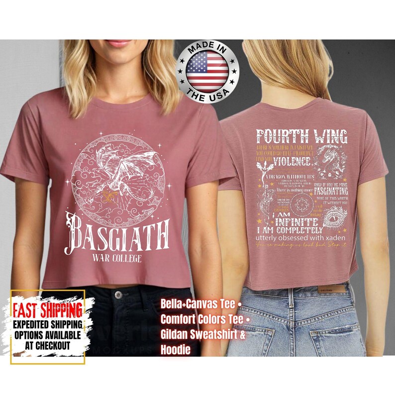 May include: Dusty rose crop top with a white graphic of a dragon inside a circle, the text "BASGIATH WAR COLLEGE" below. The back of the shirt features text and a dragon graphic. Made in the USA.
