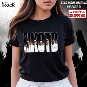 May include: Black crew neck t-shirt featuring the band NKOTB in a white and black design. The band members are shown in a row, with the band's name above them. The shirt also has the words "FIND MORE DESIGNS ON PAGE 2!" and "FAST SHIPPING".