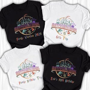 May include: Four t-shirts, two black and two white, with a Universal Studios graphic. The graphic includes the text "UNIVERSAL STUDIOS" and various phrases: "Family Vacation 2026", "Girls Trip", "Family Birthday Trip", and "Evie's 10th Birthday".