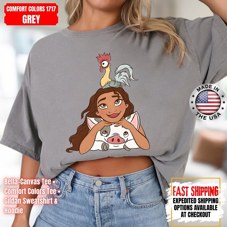 May include: Grey Comfort Colors t-shirt featuring a cartoon illustration of a character with a pig and a rooster. The shirt has the text "Comfort Colors 1717 GREY" and "Made in the USA". The shirt is a Bella-Canvas Tee, Comfort Colors Tee, or Gildan Sweatshirt & Hoodie.