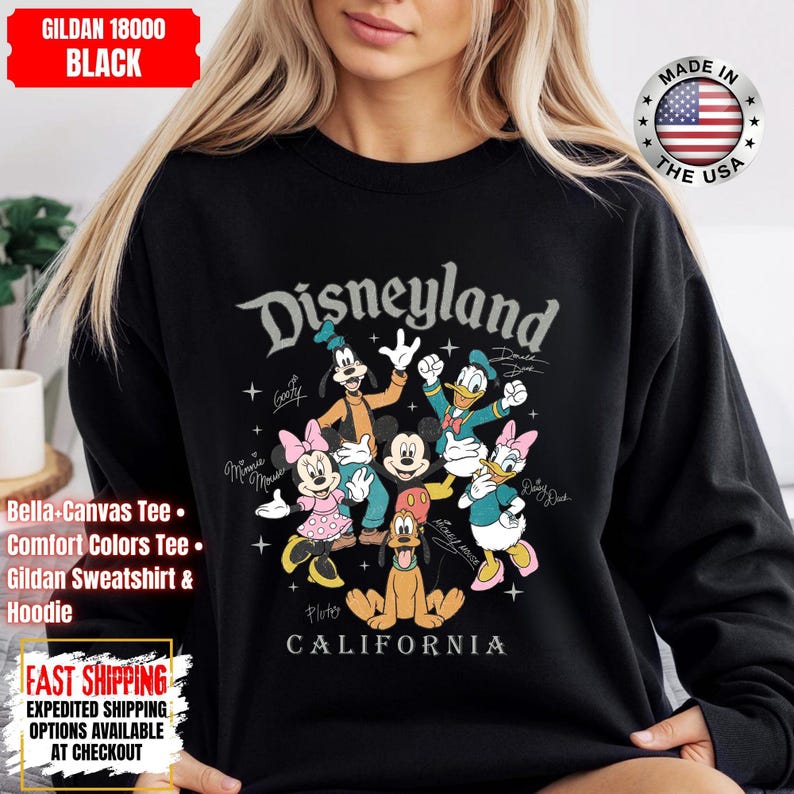 May include: Black Disneyland sweatshirt featuring Mickey Mouse, Minnie Mouse, Donald Duck, Daisy Duck, Goofy, and Pluto. The text "Disneyland" and "California" are printed on the front. Made in the USA.