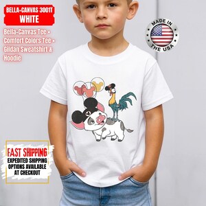 May include: White Bella-Canvas tee shirt featuring a cartoon illustration of a pig, rooster, and balloons. The shirt has the text "BELLA-CANVAS 3001T WHITE" and "MADE IN THE USA".