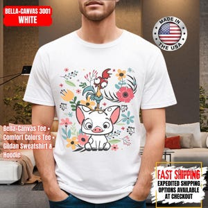 May include: White t-shirt with a vibrant graphic of a pig, rooster, and floral elements. The design includes the text "BELLA+CANVAS 3001 WHITE". The shirt is a Bella+Canvas Tee, Comfort Colors Tee, or Gildan Sweatshirt & Hoodie.