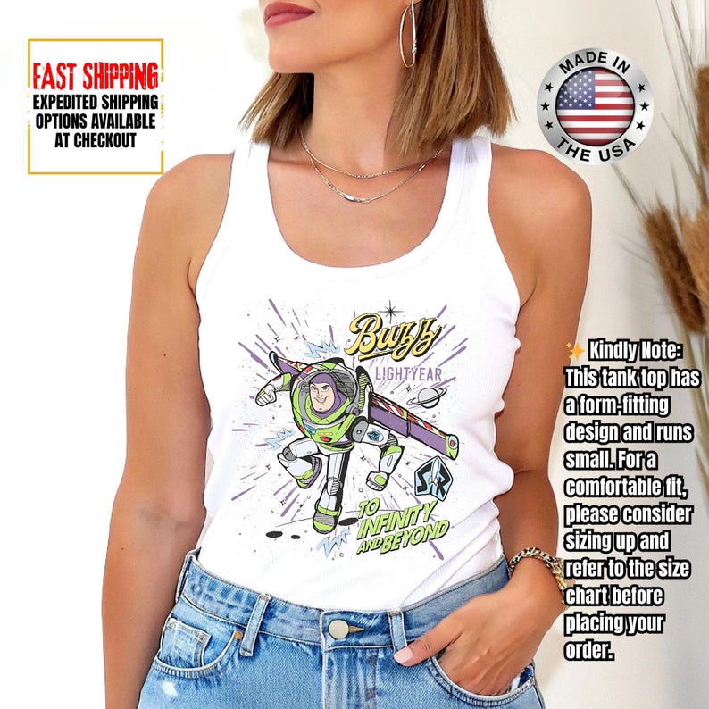 May include: White tank top with a Buzz Lightyear graphic and the phrases "Buzz Lightyear" and "To Infinity and Beyond." The tank top has a form-fitting design. Made in the USA.