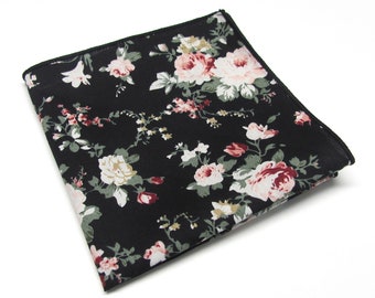 May include: A black pocket square with a floral pattern featuring pink and white flowers on a black background.