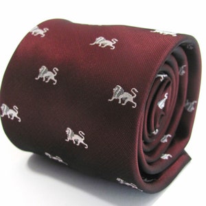 May include: A maroon necktie with a white lion pattern.