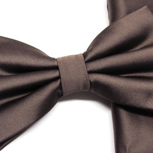 May include: A brown satin bow tie with a matching pocket square.