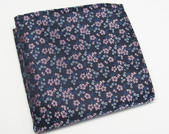 May include: A dark blue pocket square with a pink and white floral pattern.