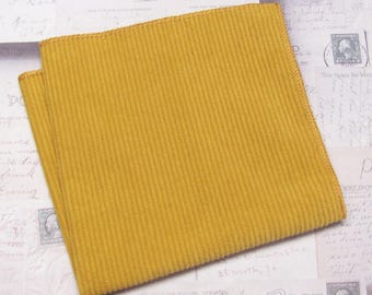 May include: A yellow ribbed fabric swatch. The fabric has a soft, textured surface.