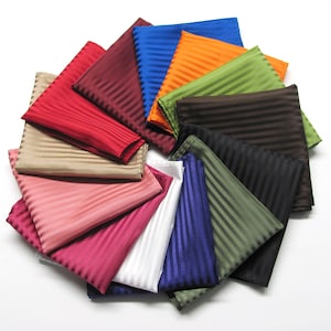 May include: A collection of striped pocket squares in various colors, including red, brown, green, blue, and white. The squares are arranged in a circular pattern.