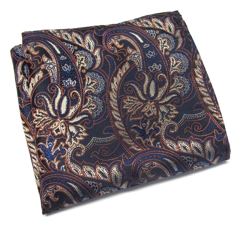 May include: A dark blue paisley pocket square with a gold and orange floral pattern.