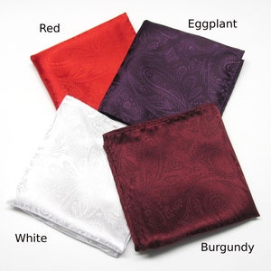 May include: Four paisley pocket squares in red, aubergine, white, and burgundy. Each square is folded and displayed with the colour name in the corner. The fabric has a subtle sheen.