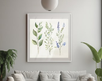 Könnte beinhalten: Ein weißes Sofa mit drei weißen Kissen steht vor einer weißen Wand mit einem gerahmten Aquarellbild von grünen und blauen Blütenstielen. Ein brauner Holz-Couchtisch mit schwarzen Beinen steht vor dem Sofa.