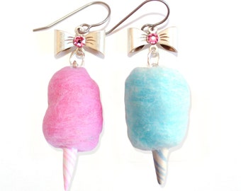 May include: A pair of cotton candy earrings with pink and blue cotton candy and silver bows with pink rhinestones.