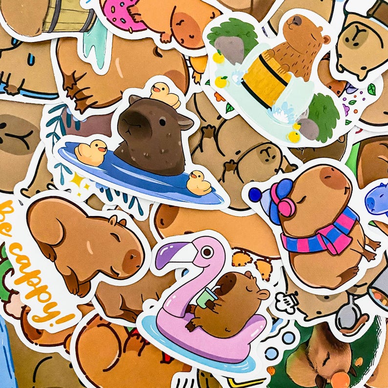 May include: A collection of colorful stickers featuring cartoon capybaras in various activities, including surfing, swimming, and relaxing on a flamingo float. The stickers have a whimsical and playful style, with bright colors and detailed illustrations.