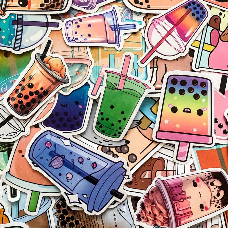 May include: A collection of colorful bubble tea stickers featuring various designs, including a green tea with boba, a blue space-themed cup, a pink and purple popsicle with a face, and a brown cup with a pink and white swirl design.