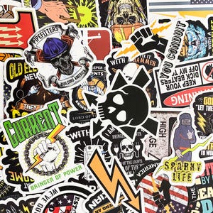 May include: A collection of colorful stickers featuring various designs related to the electrical trade. The stickers feature skulls, lightning bolts, and phrases like "Bringer of Power", "Current", "I am Bringer", and "Sparky Life".