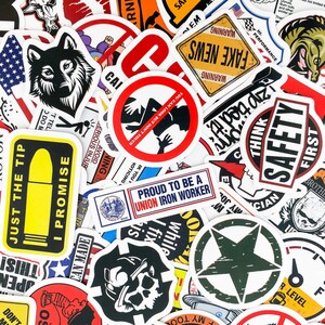 May include: A collection of colorful stickers with various designs, including a wolf, a warning sign, a safety sign, a star, and a skull. The stickers are printed on white paper and have a glossy finish.