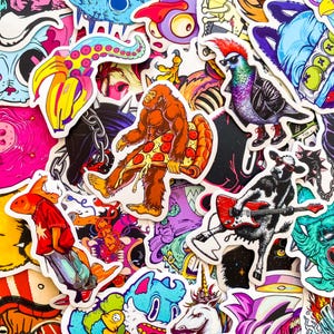 May include: A collection of colorful stickers with various cartoon characters and designs. Includes a Bigfoot holding pizza, a pigeon in a leather jacket, a cow playing guitar, and a banana with tentacles.