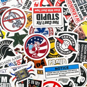 May include: A collection of colorful stickers with various designs and phrases. Some of the stickers feature humorous sayings like "You Can't Fix Stupid" and "Don't Make Me Open 100% of My Ass!"  Others feature images of a rat, a spartan helmet, and a cartoon electrician.