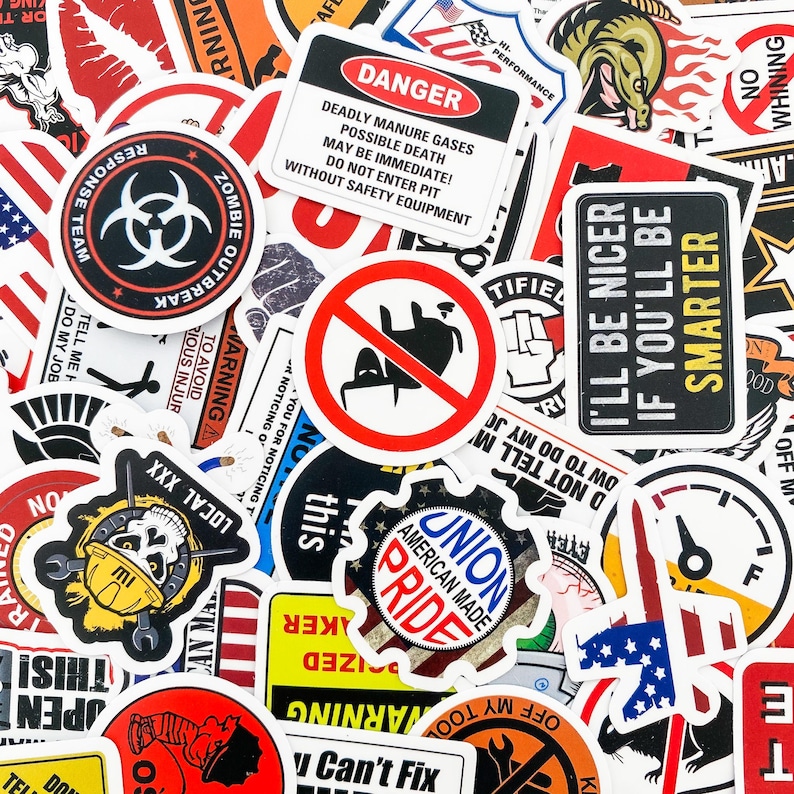 May include: A collection of colorful stickers with various designs and text. Some of the stickers feature American flags, skulls, and warning signs. The text on the stickers includes phrases like "Zombie Outbreak", "I'll Be Nicer If You'll Be Smarter", and "Union American Made Pride".