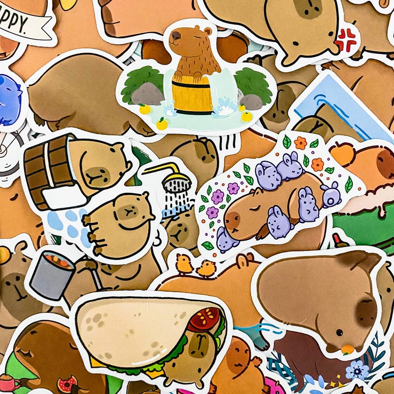 May include: A collection of colorful stickers featuring cartoon capybaras in various poses and settings. The stickers include images of capybaras taking a bath, eating, and relaxing. There are also stickers with text, such as "Happy" and "Capybara".