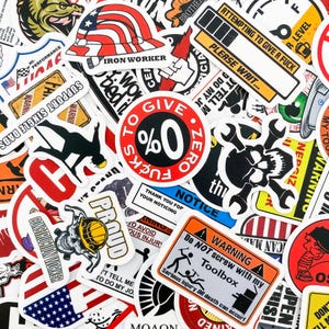 May include: A collection of colorful stickers with various designs and slogans. Some of the stickers feature American flags, skulls, and construction-themed imagery. The stickers have a variety of fonts and colors, including red, white, blue, black, and yellow.