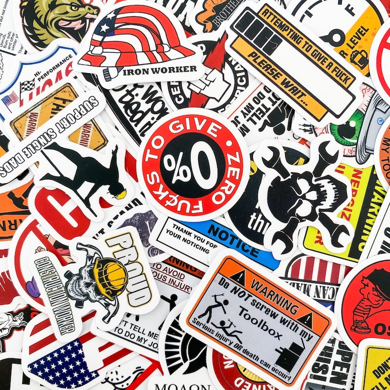 May include: A collection of colorful stickers with various designs and slogans. Some of the stickers feature American flags, skulls, and construction-themed imagery. The stickers have a variety of fonts and colors, including red, white, blue, black, and yellow.