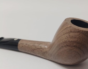 May include: A brown wooden pipe with a black mouthpiece. The pipe has a smooth, polished finish and a slightly curved stem.