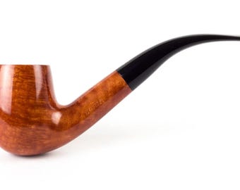 May include: A classic tobacco pipe with a polished, light brown bowl and a dark, curved stem. The pipe features a smooth, glossy finish, and is set against a clean white background. The stem is black and curves gracefully.