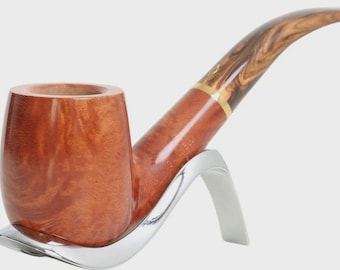 May include: A polished brown wooden tobacco pipe with a smooth, rounded bowl and a curved stem featuring a distinct wood grain pattern. The pipe is supported by a sleek, silver-coloured metal stand with a curved, modern design.