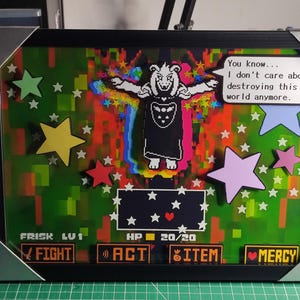 May include: Framed artwork featuring a character from the video game Undertale. The image includes a character with outstretched arms, a speech bubble with text, and a game interface with text and hearts. Colorful stars are scattered around the image.