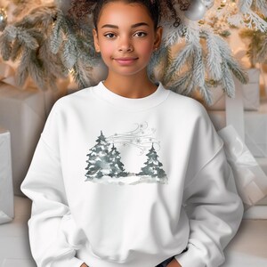 May include: White sweatshirt with a watercolor-style winter scene featuring two evergreen trees and snowflakes. The design is subtle and elegant, perfect for the holiday season. The sweatshirt is a relaxed fit, suitable for casual wear.  It's a comfortable and stylish choice for winter.