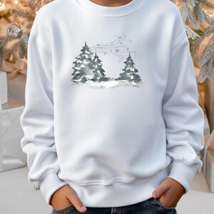 May include: White sweatshirt with a watercolour illustration of two fir trees in a snowy scene, with wind and snowflakes. The design uses grey and blue tones.