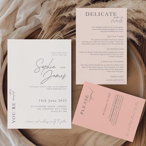 May include: A wedding invitation suite with a minimalist design. The main invitation card is white with black text and features the names "Sophia and James" in cursive script. The RSVP card is pink with black text and says "Please RSVP by January 1, 2025".