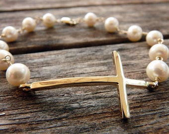 14 karat yellow gold cross bracelet on saltwater Akoya cultured pearls