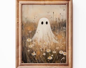 May include: A framed painting depicting a white ghost with black eyes amidst daisies and tall grass. The artwork has a vintage aesthetic with a soft palette of beige, brown, and white. The frame is a light brown colour.