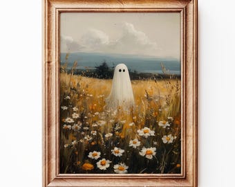 May include: A framed art print shows a white ghost in a field of wildflowers. The ghost has two black eyes. The background features a landscape with a blue mountain range and a cloudy sky. The frame is light brown. The text "ExpressMockupsArt" is at the bottom.