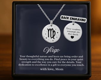 May include: A silver Virgo zodiac pendant necklace displayed in a black box. The pendant features the Virgo symbol and a smaller disc for custom engraving. Text on the box reads "Your custom message on the back."