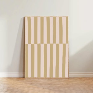 May include: A framed print with a geometric pattern of vertical and horizontal stripes in shades of beige and pink.