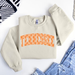a white sweatshirt with the word tennessee printed on it