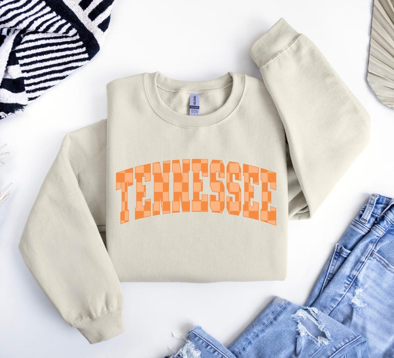 a white sweatshirt with the word tennessee printed on it