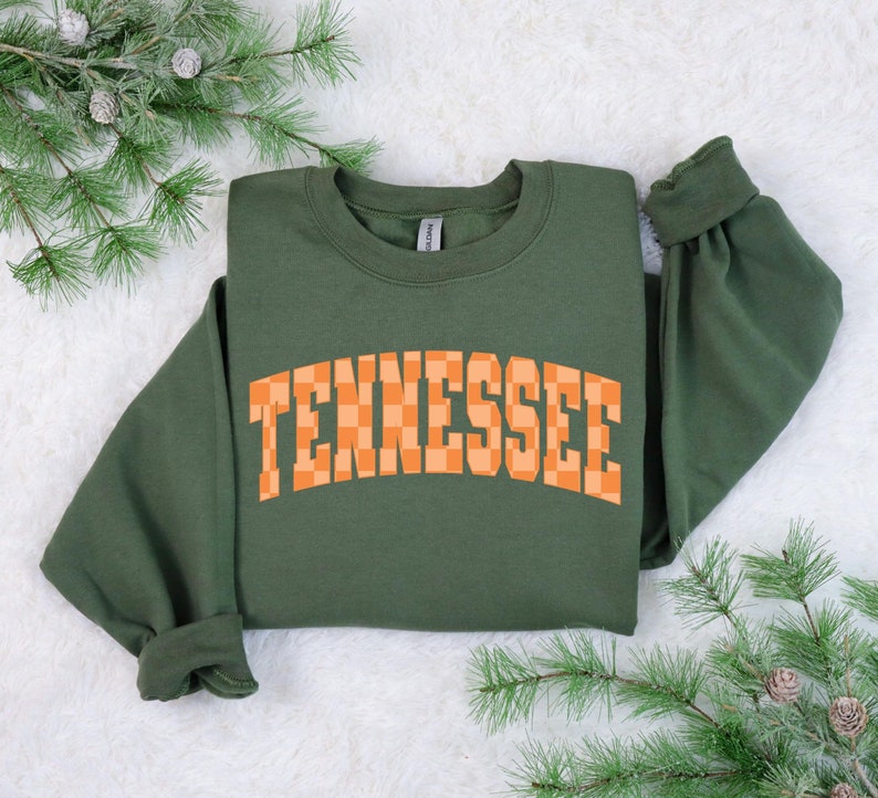 a green sweatshirt with the word tennessee on it