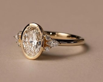 May include: A gold ring featuring a central oval-cut diamond set in a smooth bezel setting. The band is accented on each side by a cluster of three smaller marquise-cut and round-cut diamonds, creating a balanced and detailed design.