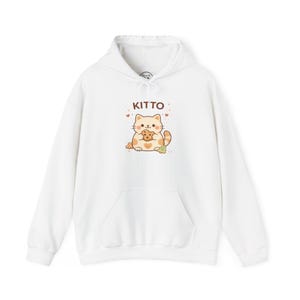 May include: White hoodie with a front pocket and drawstring. The hoodie features a cartoon cat graphic holding a cookie, with the word "KITTO" above the cat. The cat is orange and white, with brown accents.