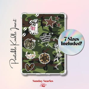 May include: A clear Kindle case with a camouflage pattern insert featuring various stickers. Stickers include a ghost, pumpkin, star, and skeleton. The text "My Emotional Support Kindle" is visible. The image also includes the text "7 Sizes Included!"